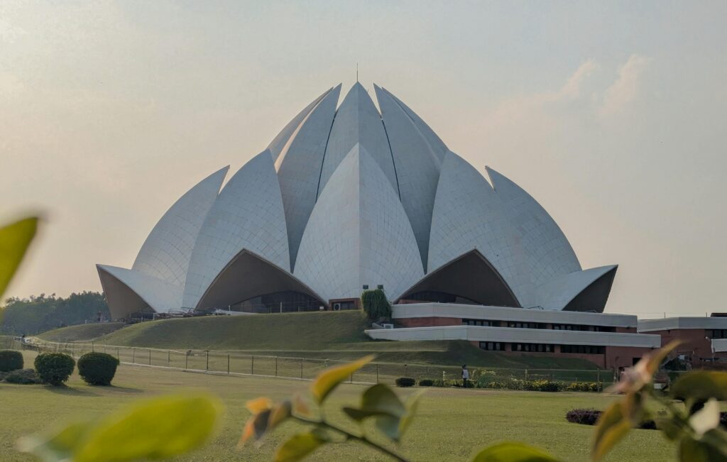 Stunning view of the iconic Lotus Temple in New Delhi, showcasing its architectural elegance under a clear sky.