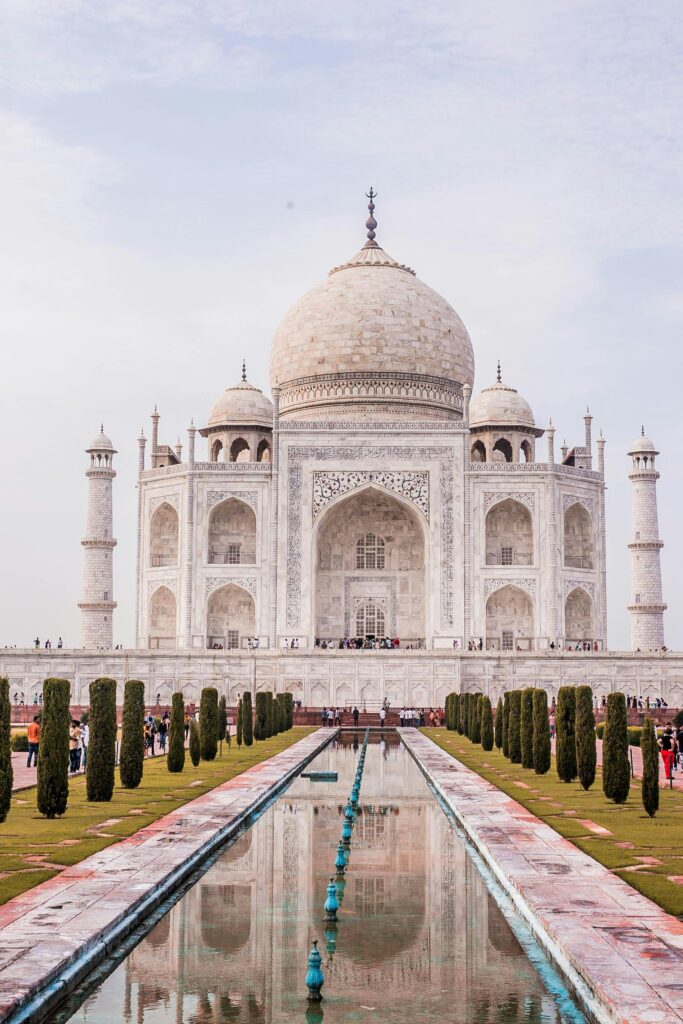 Captivating photo of the iconic Taj Mahal reflecting in a water pond, Agra, India.