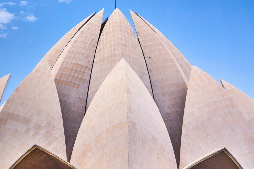 A captivating view of the iconic Lotus Temple in Delhi with a clear blue sky backdrop.