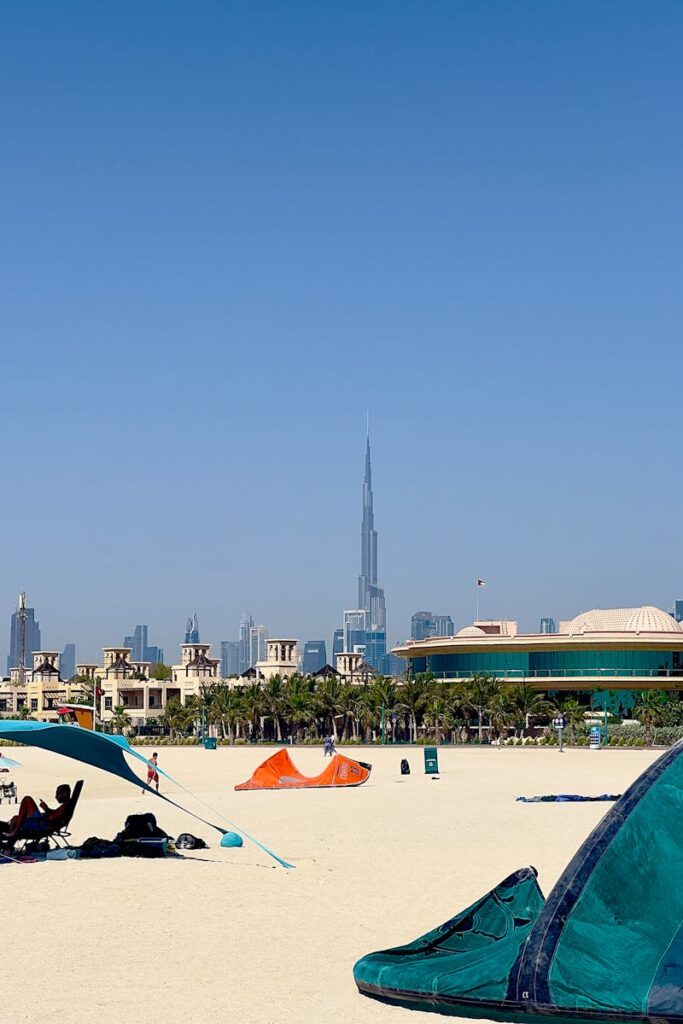 A scenic view of a Dubai beach with Burj Khalifa in the skyline.